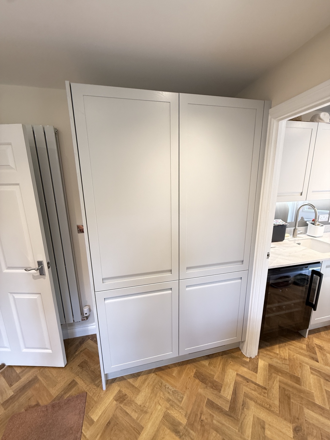 Shaker storage cabinets fitted beside a doorway