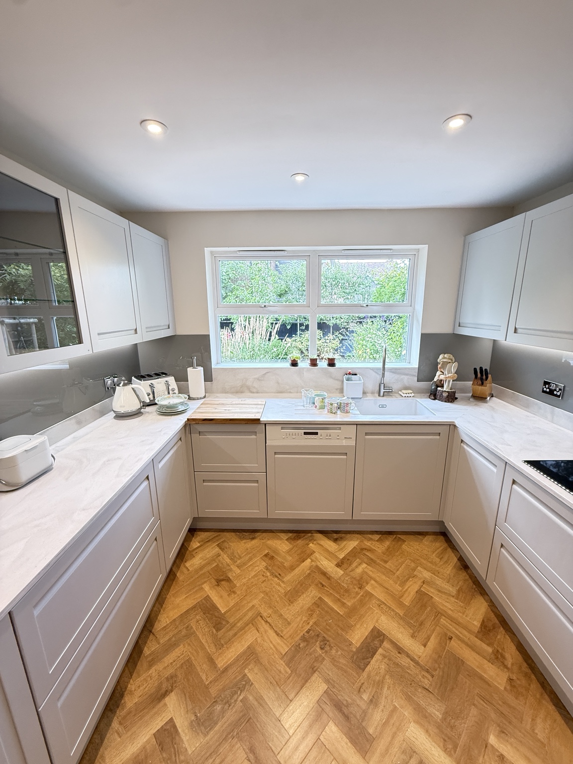 Finished grey Shaker kitchen facing the sink and garden window