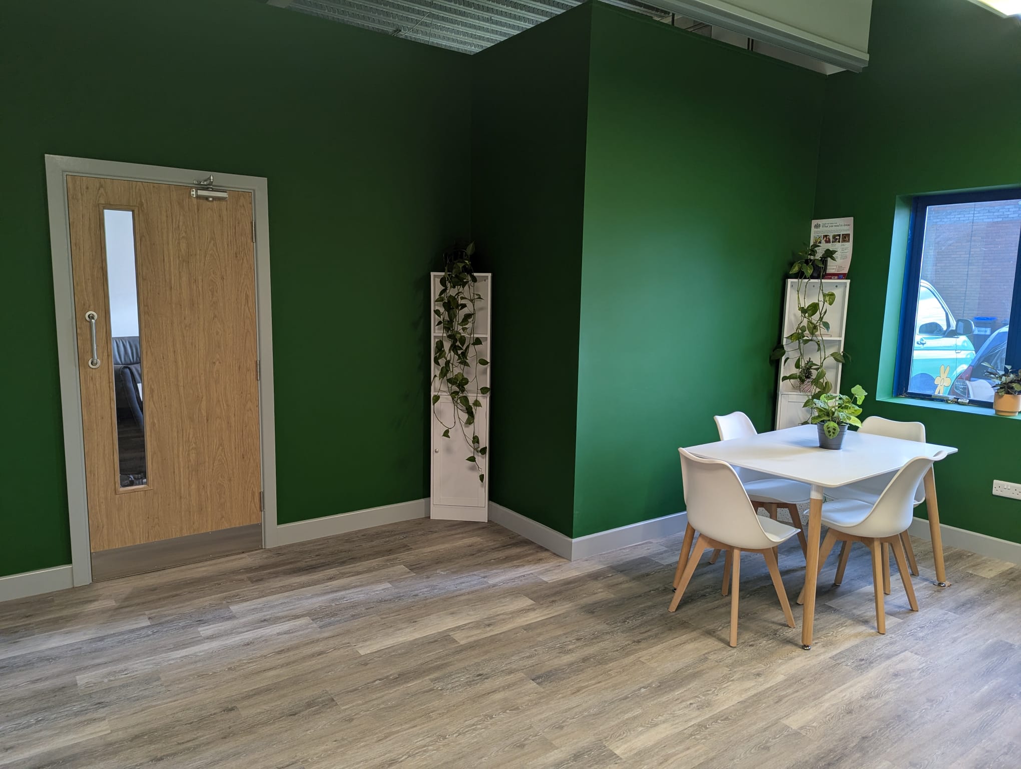 Completed WAER breakout area with green walls and timber door