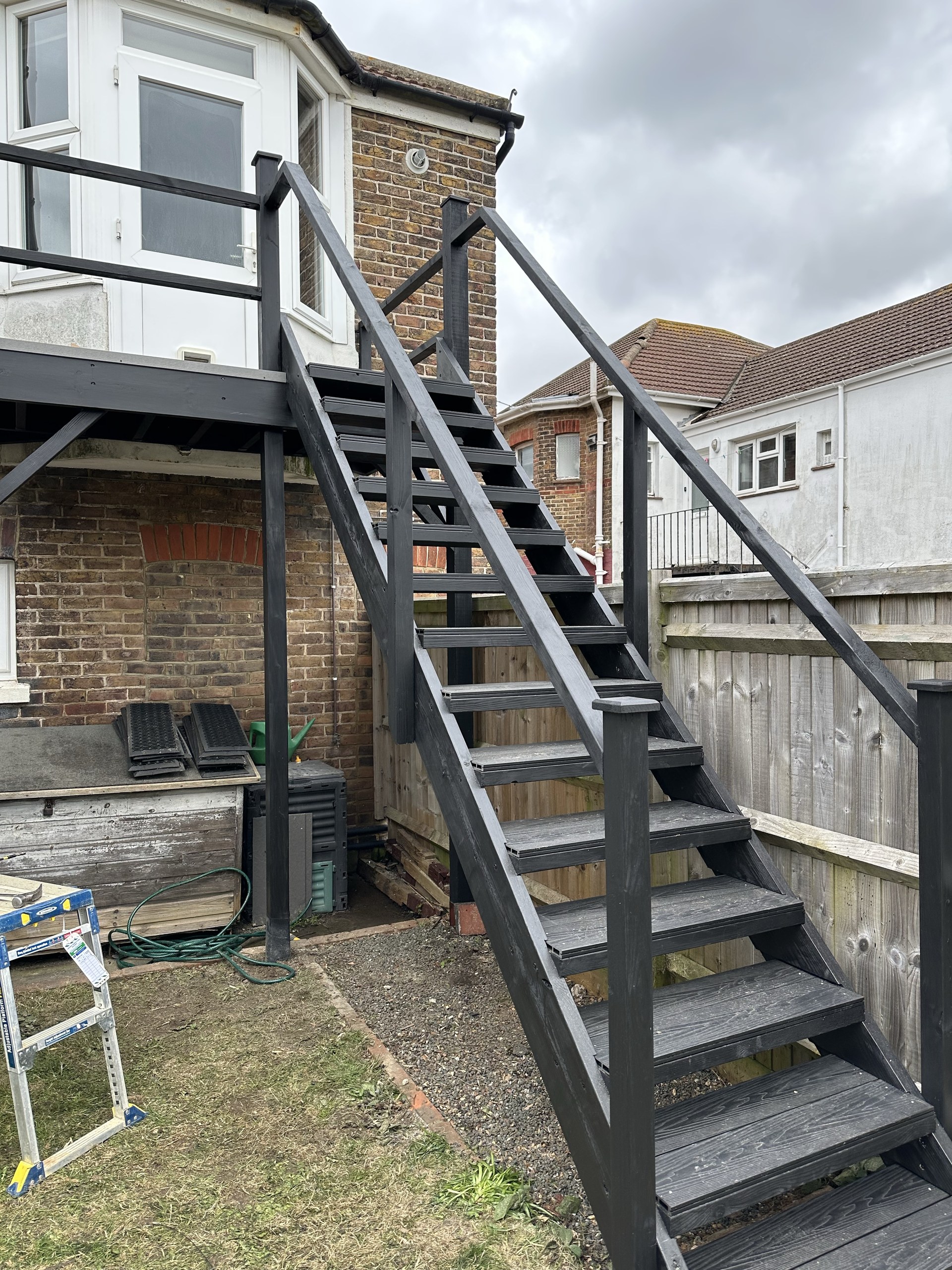 Rebuilt and redecorated external staircase with dark painted timber rails and treads in Worthing
